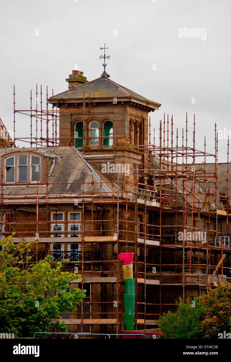 Scaffolding around large house renovation Stock Photo