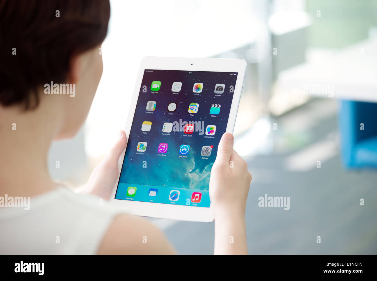 Woman holding brand new white Apple iPad Air, the most advanced digital tablet in part of the iPad line Stock Photo