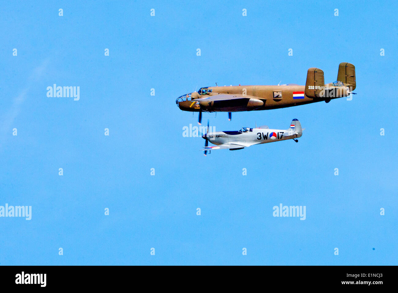 Sword Beach, Ouistreham, France. 6th June, 2014. A North American B-25 Mitchell 232511 (top) and a Spitfire perform during the the D-Day commemoration to mark the allied invasion 70 years ago at Sword Beach, Ouistreham, France, 6 June 2014. Photo: Patrick van Katwijk NETHERLANDS AND FRANCE OUT NO WIRE SERVICE/dpa/Alamy Live News Stock Photo