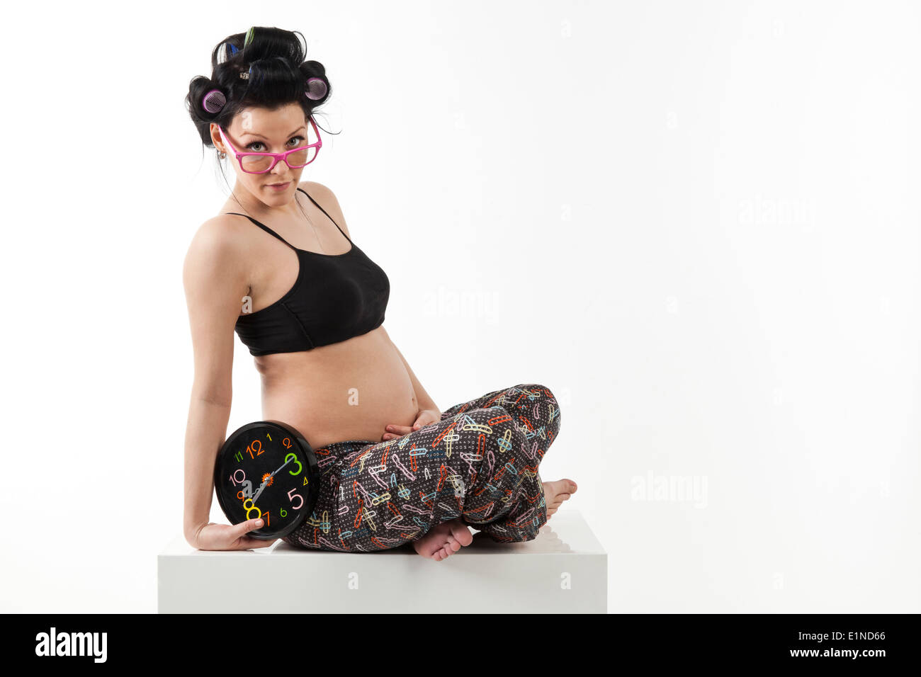 pregnant young women with clock and glasses Stock Photo