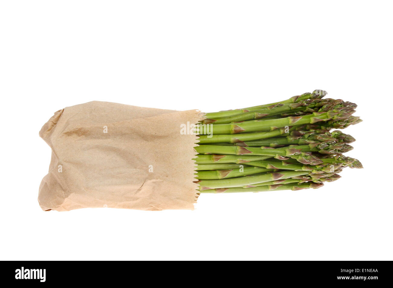 Bunch of asparagus wrapped in brown paper isolated against white Stock Photo