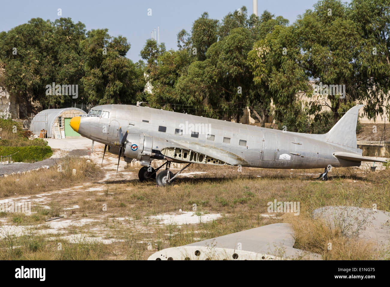 Silver Dakota Douglas DC-3 aircraft with detached wing, in need of restoration, at Malta Aviation Museum, Mdina, Malta Stock Photo