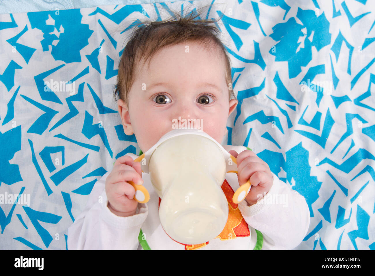 Six Month Old Baby Drinking Milk From A Bottle With The Teat Stock