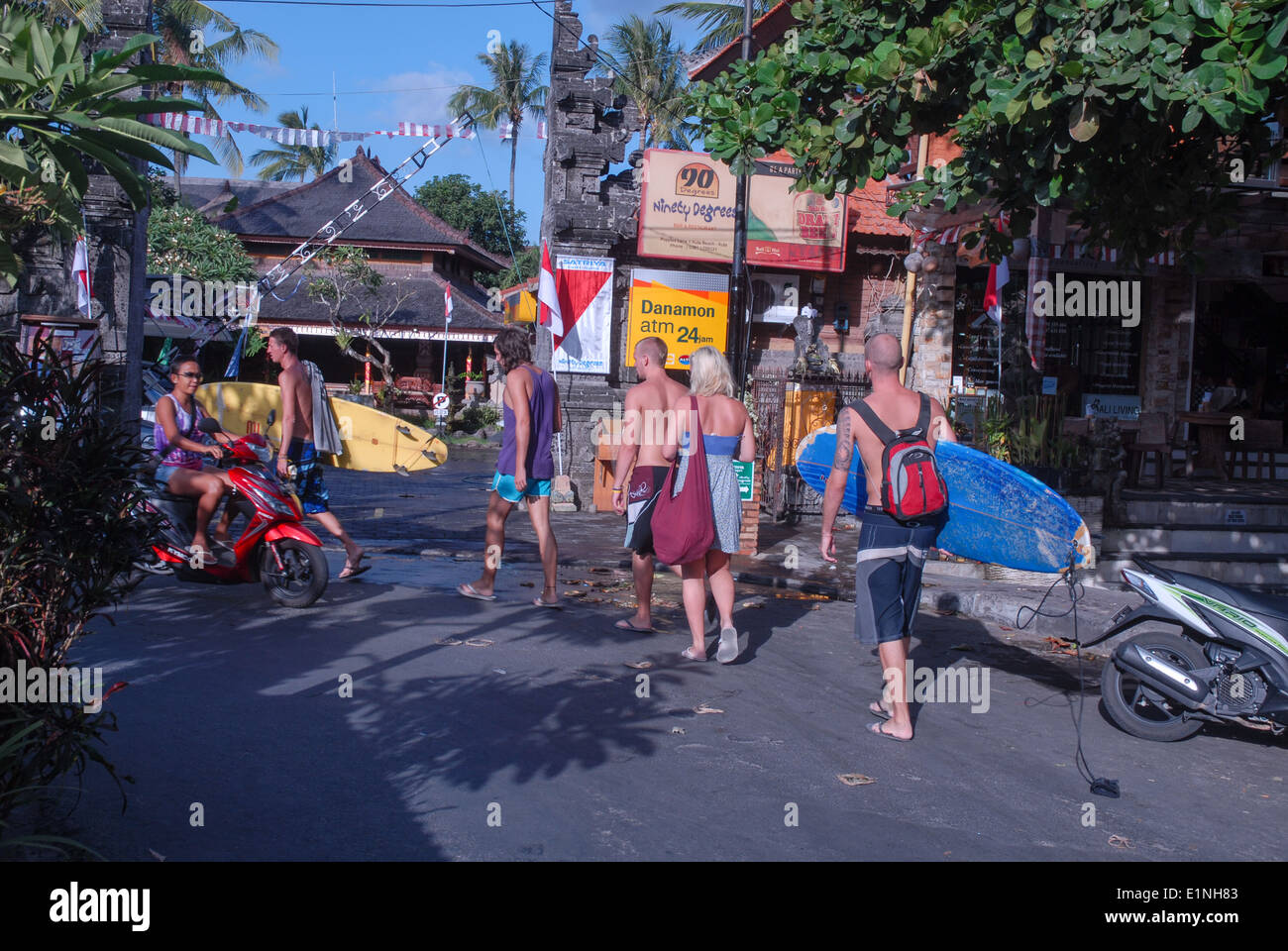 couple of backpackers at street in Kuta on Bali, Indonesia Stock Photo