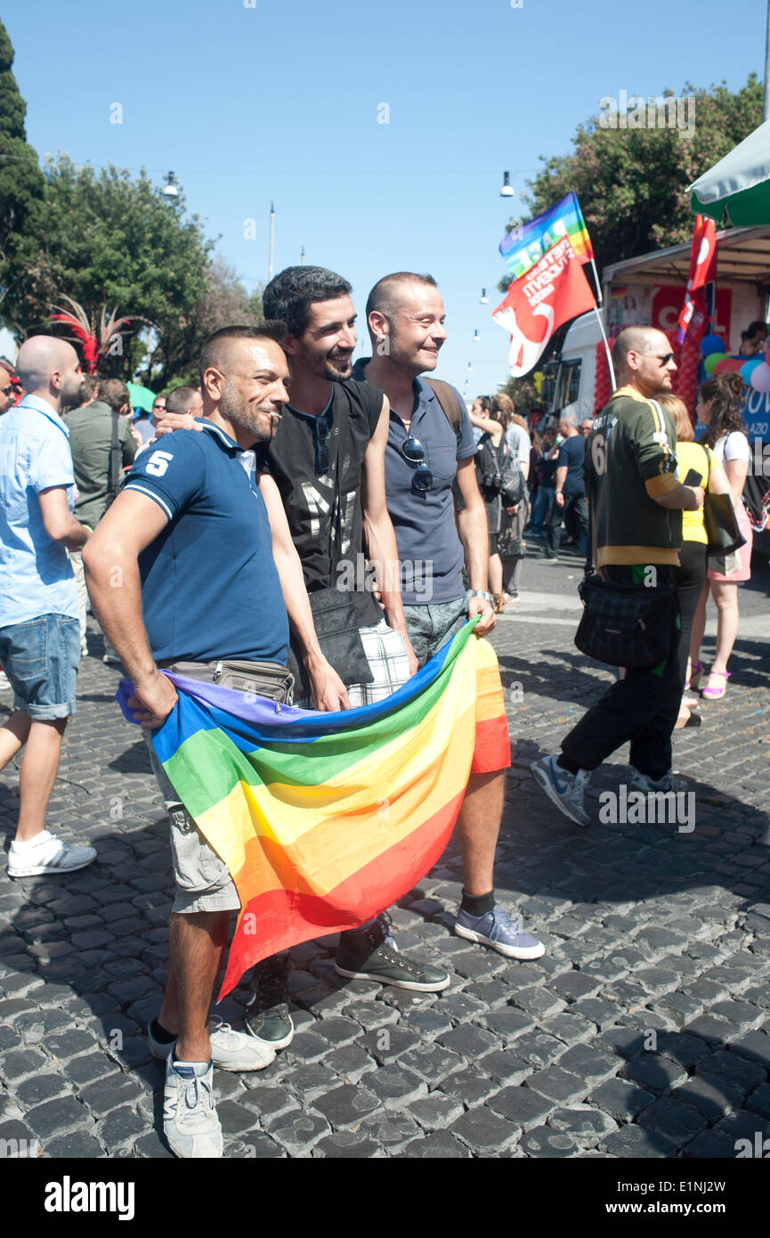 Rome, Italy. 06th July, 2014. Gay Pride March in Rome: Pictured: Three men  holding the rainbow flag posing for the camera Credit: Carlo A. -  images/Alamy Live News Stock Photo - Alamy