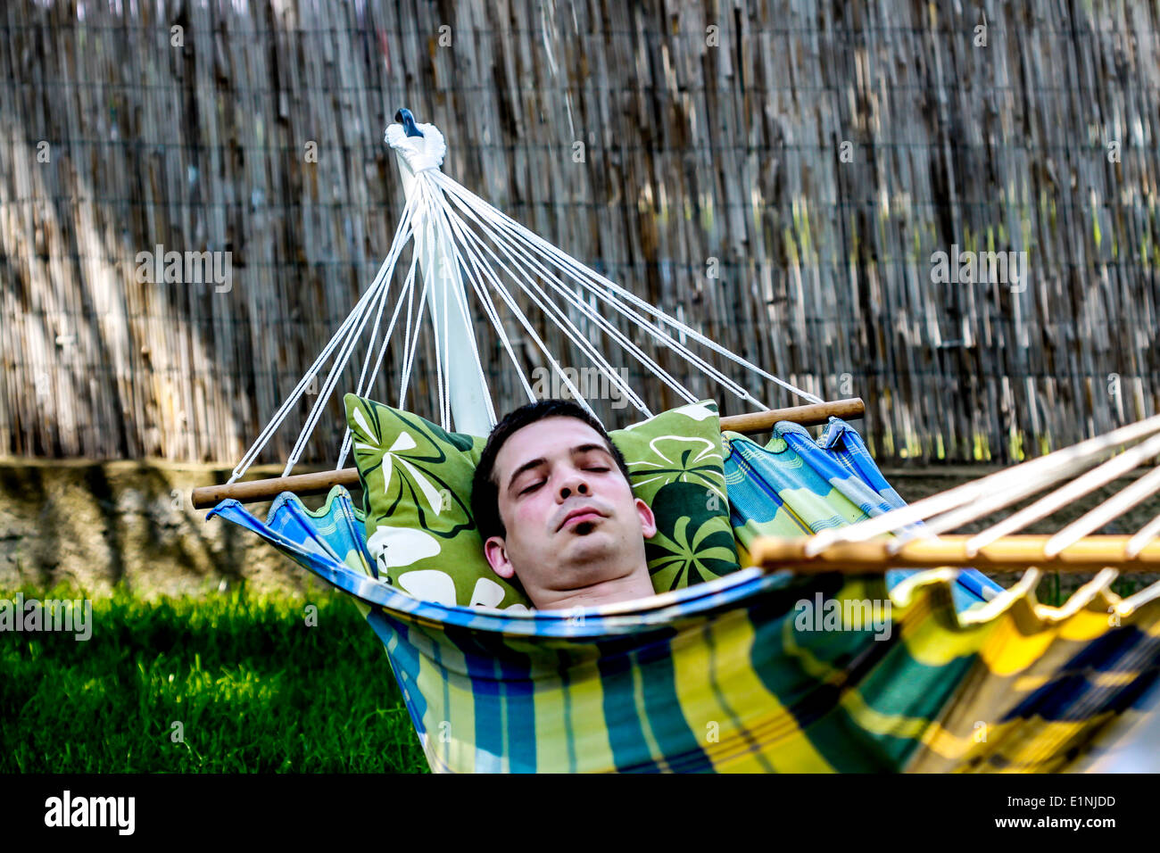 Man napping in a hammock in the garden Stock Photo
