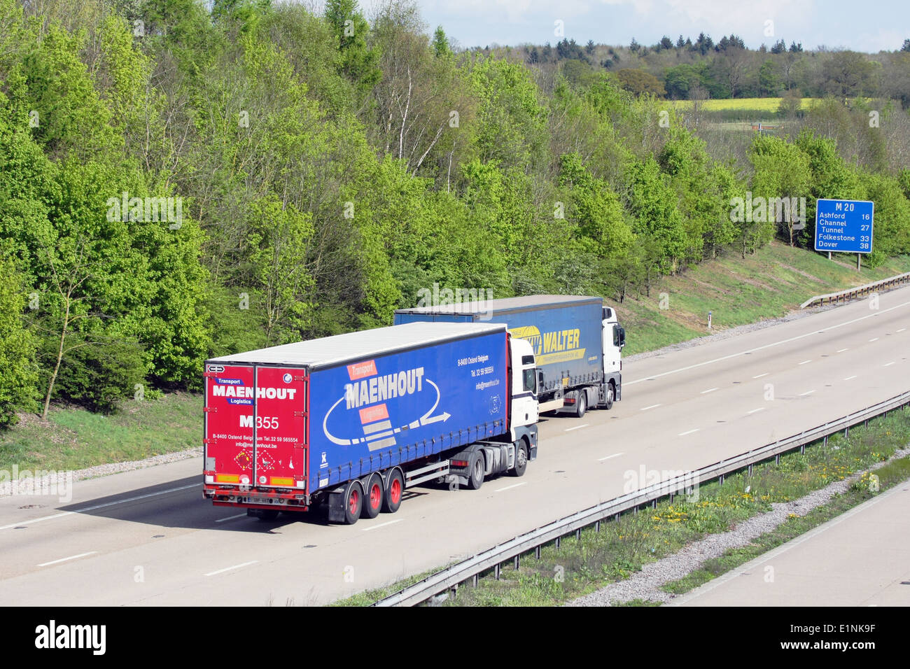 Rear view of two foreign trucks traveling along the M20 motorway in Kent, England Stock Photo