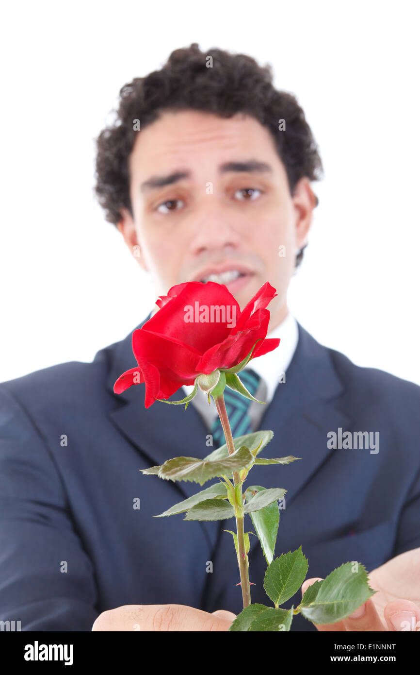 sad and emotionally affected by woman man in a suit holding a red rose and offers it to the camera Stock Photo
