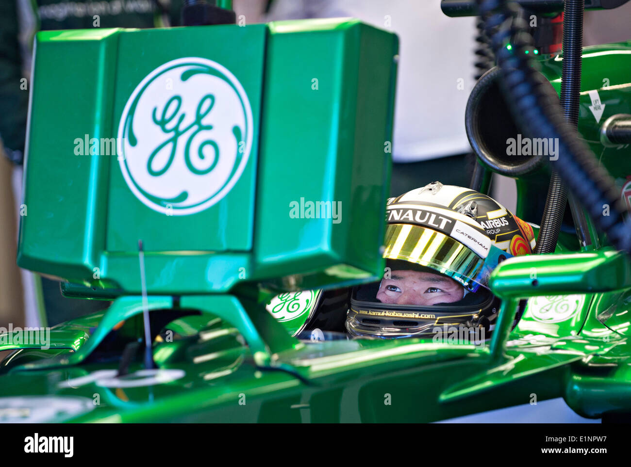 Montreal, Canada. 7th June, 2014. Caterham Formula One driver Kamui Kobayashi of Japan checks his status between laps in the pit lane during the qualifying session of 2014 Canadian Formula One Grand Prix at the Circuit Gilles Villeneuve in Montreal, Canada, on June 7, 2014. Credit:  Andrew Soong/Xinhua/Alamy Live News Stock Photo