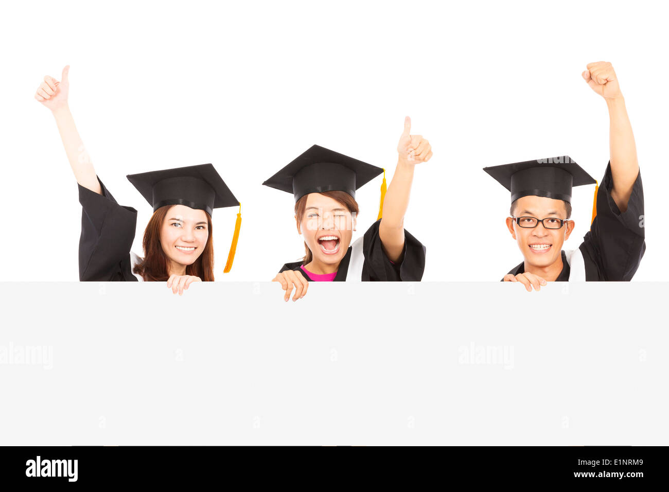 cheerful young graduate students raise hands Stock Photo