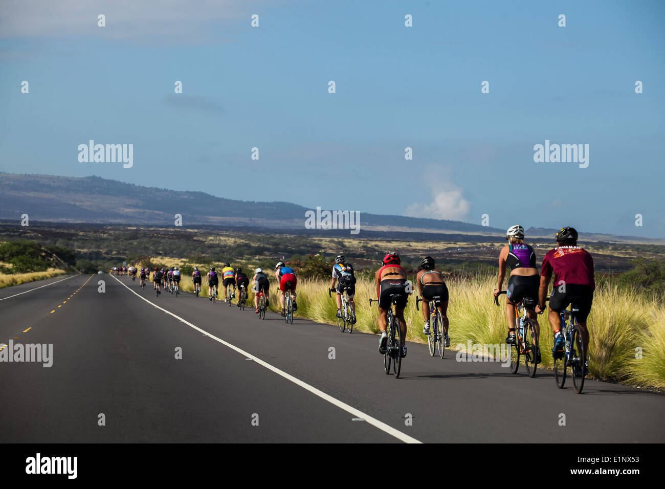 Unidentified cyclers on the Lavaman Triathlon in Waikoloa, Hawaii. It is held in Olympics format: 1.5 km swimming, 40 km biking and 10 km running. Stock Photo