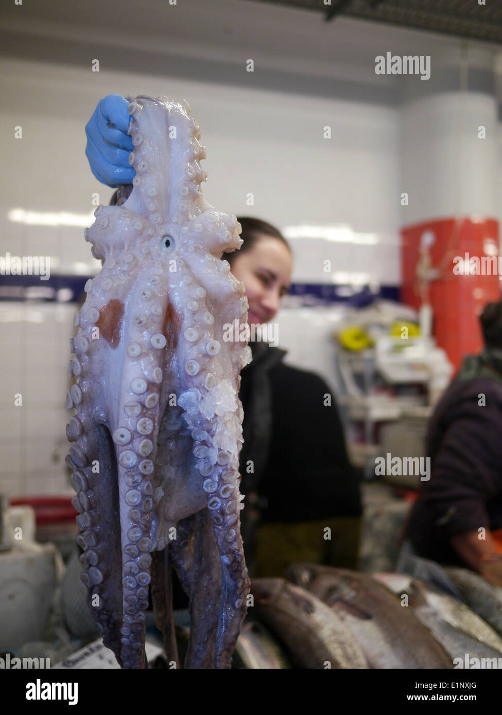 Fishmonger sells an octopus. Costa Nova, Portugal Stock Photo