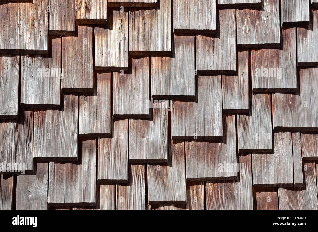 Wooden Roof Shingles - An ancient house roof, consisting of wooden roof shingles, which are arranged in a pattern. Stock Photo