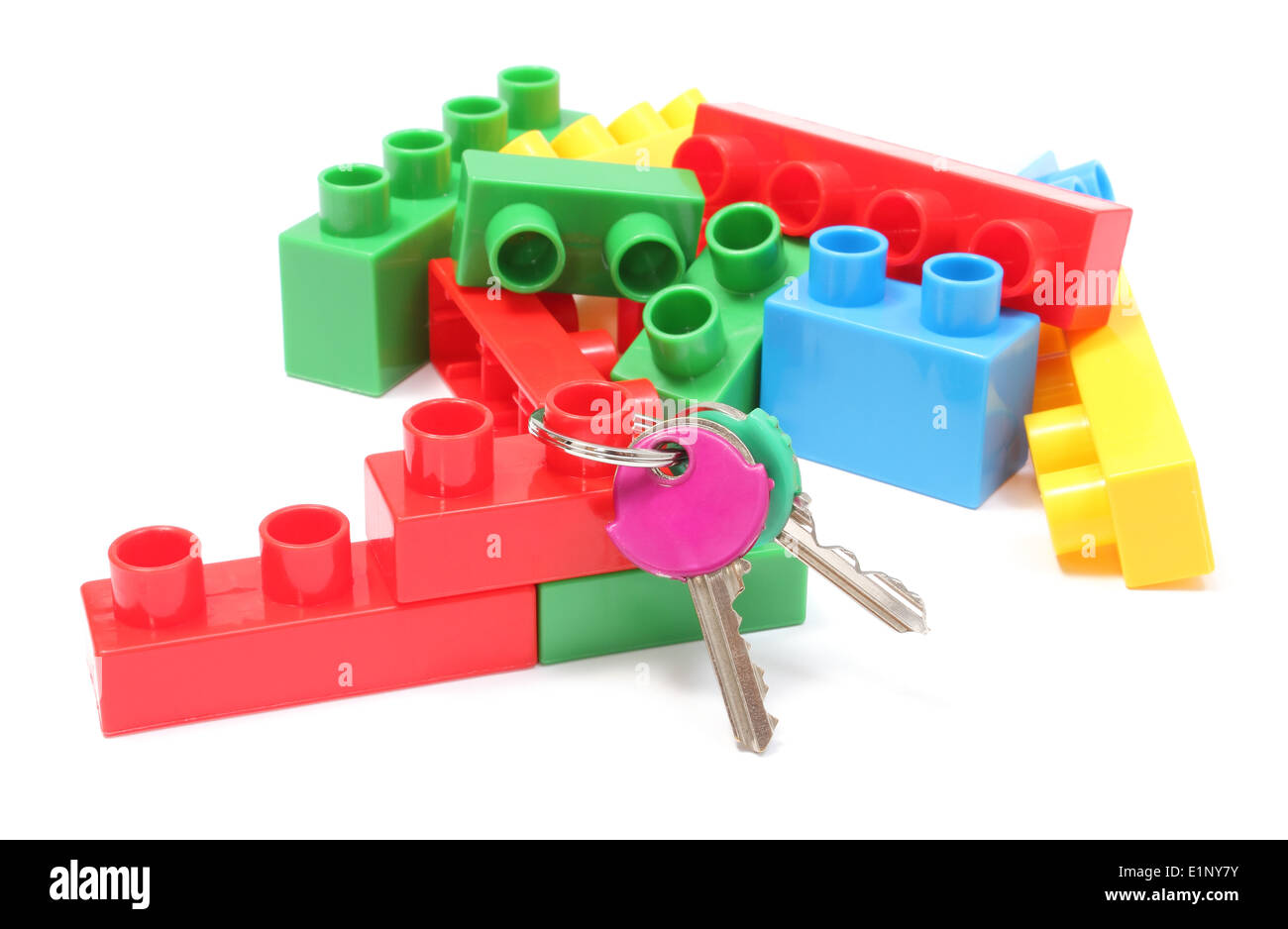 Closeup of home keys and heap of colorful building blocks, building blocks for children. Isolated on white background Stock Photo