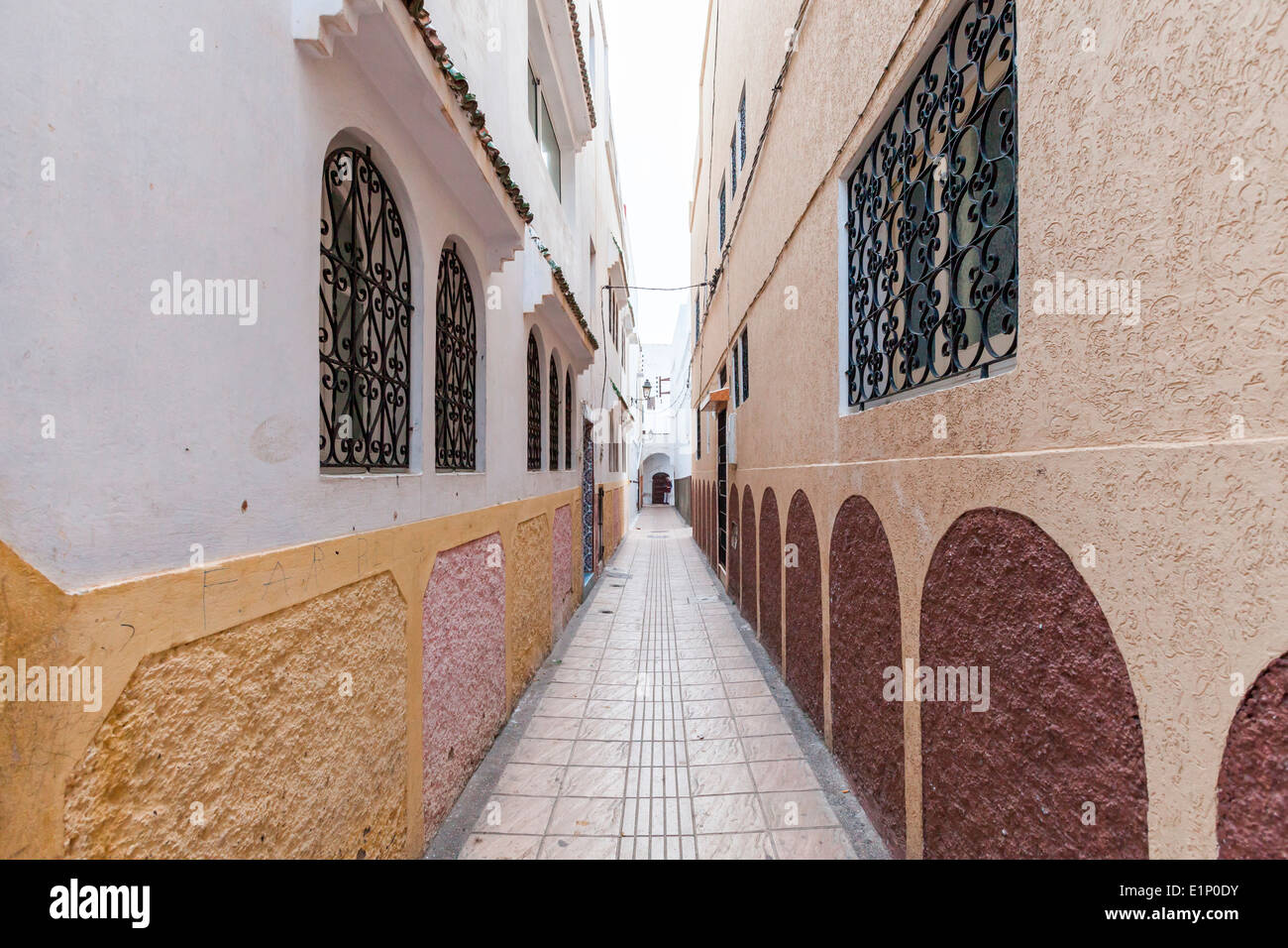 Traditional lime-washed narrow street inside the Medina in Rabat, Morocco. Stock Photo