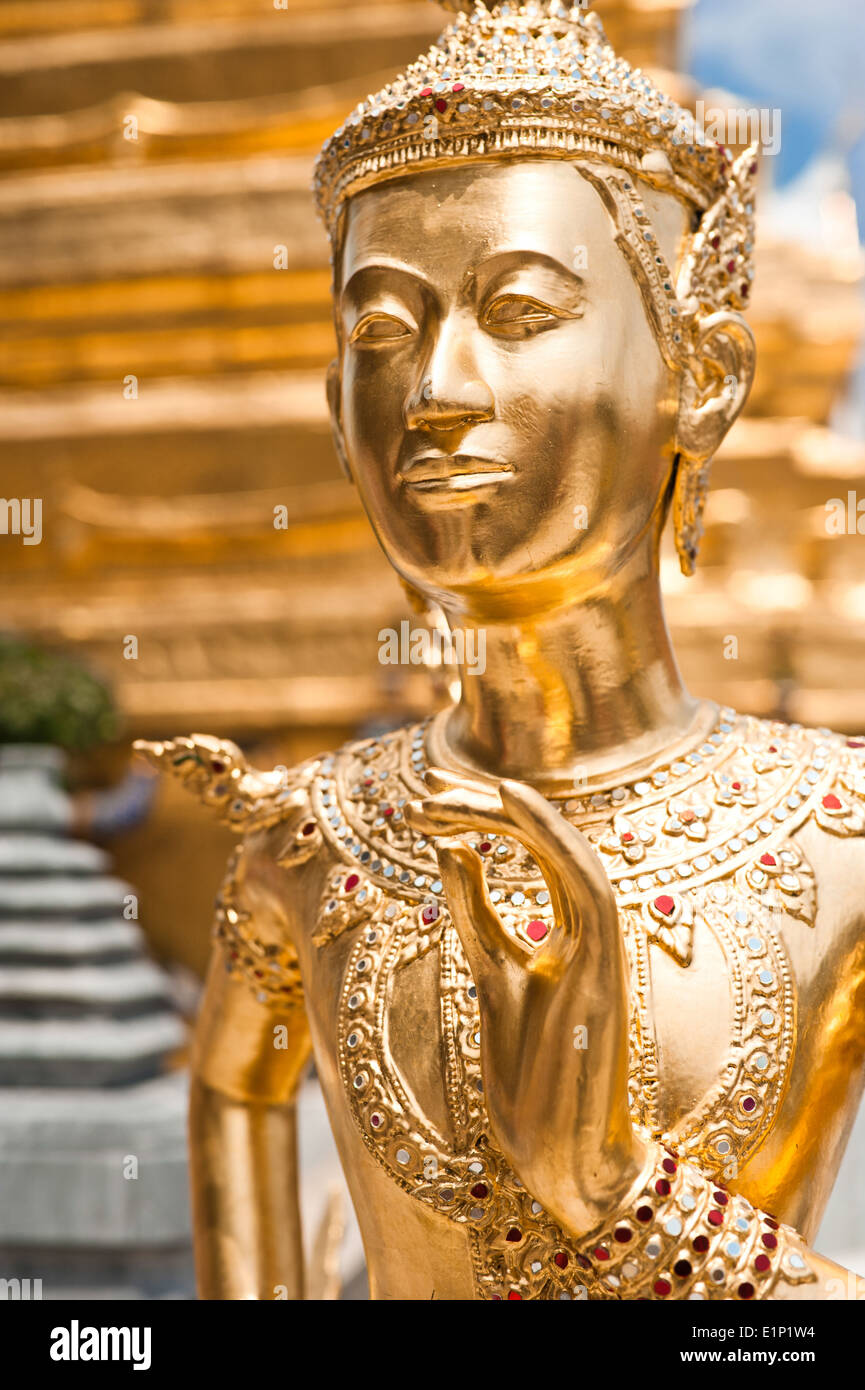 Golden Kinnari statue at Temple Emerald Buddha (Wat Phra Kaew) in Grand Royal Palace Half-bird half-woman creature at Stock Photo