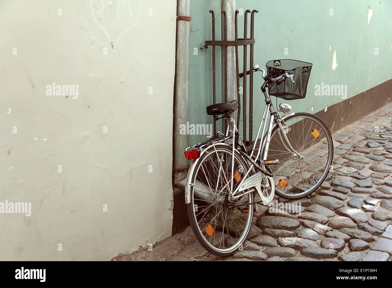 Nice bike at wall in old city at sunny day Stock Photo
