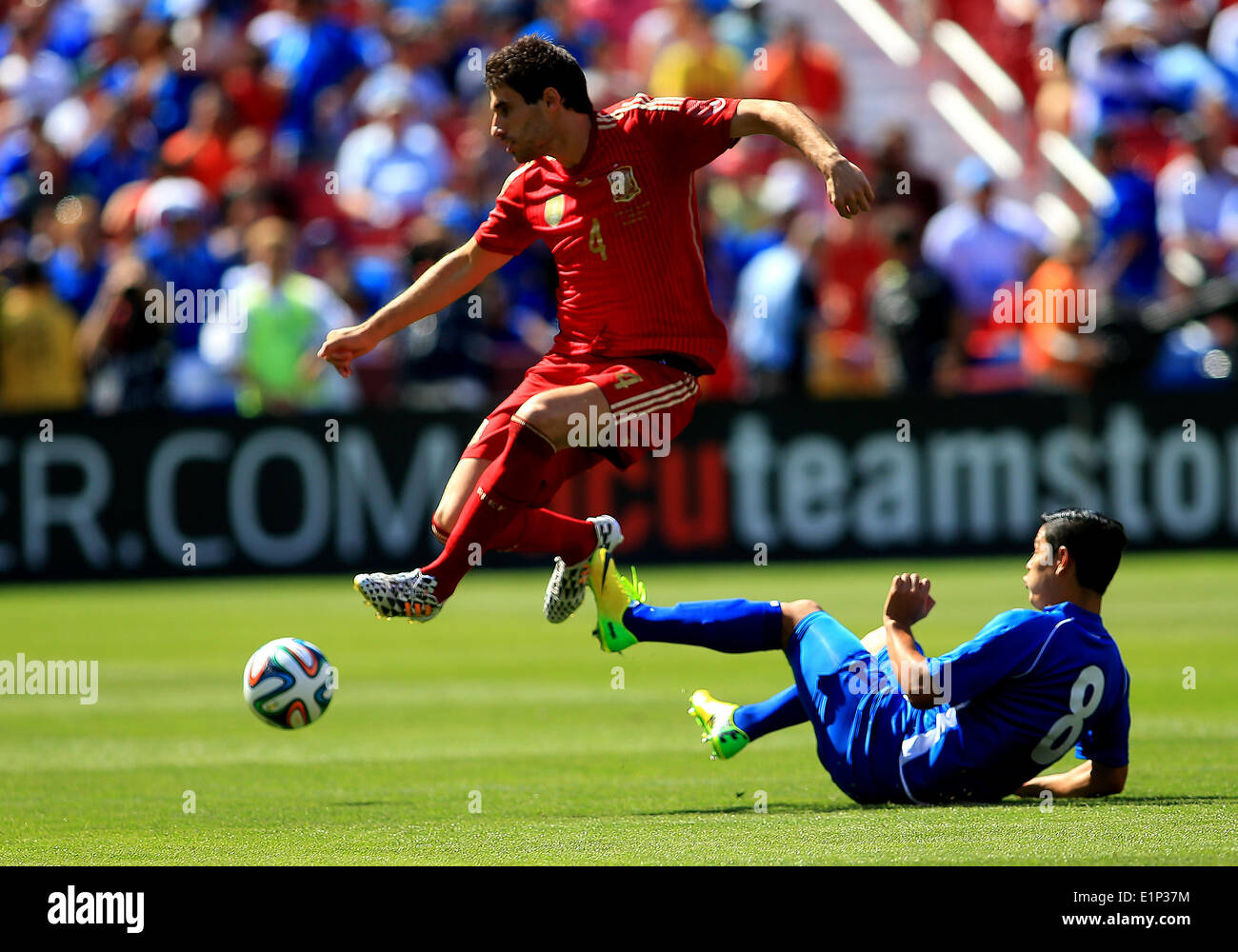 Landover, Maryland, USA. 07th June, 2014. Javi Martinez (4) of Spain leaps over Kevin Santamaria (8) of El Salvador during an international friendly match at Fedex Field, in Landover, Maryland. Credit:  Action Plus Sports/Alamy Live News Stock Photo