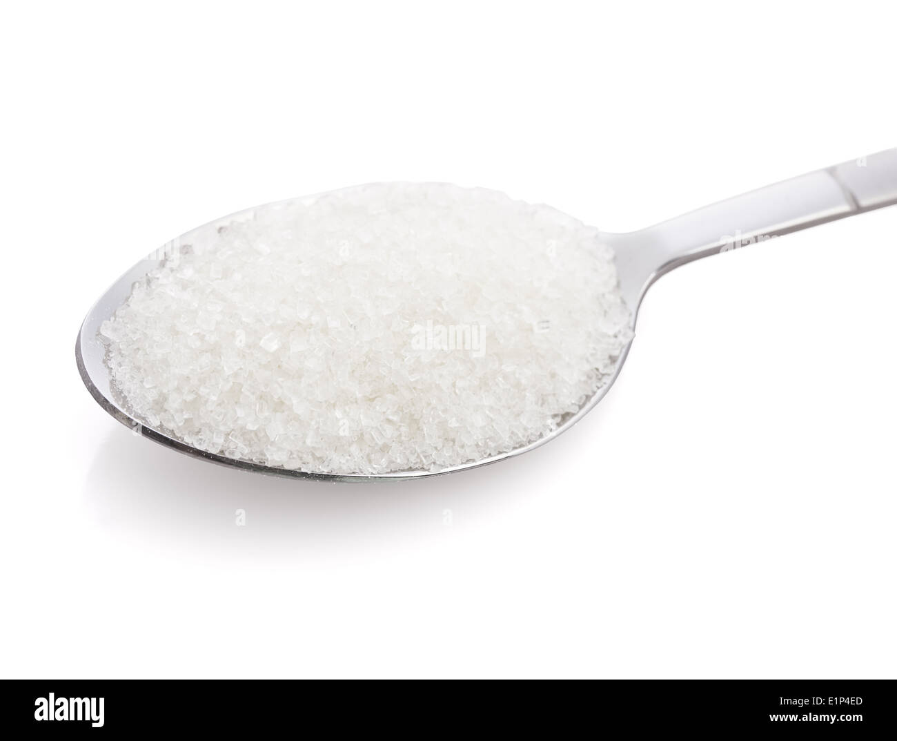 Salt or sugar on a teaspoon on white background, isolated Stock Photo