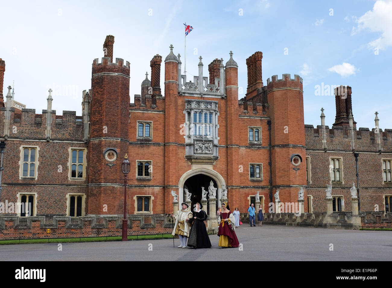 The exterior of Hampton Court Palace in the London Borough of Richmond upon Thames, UK – with Henry VIII and two wives. Stock Photo
