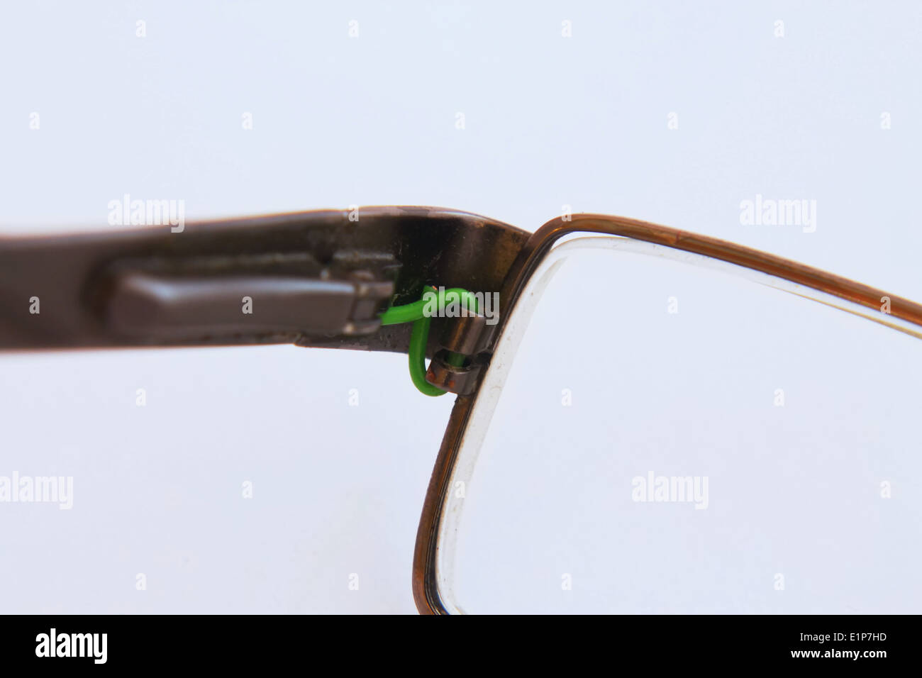 Glasses with damage fixed by green wire Stock Photo Alamy
