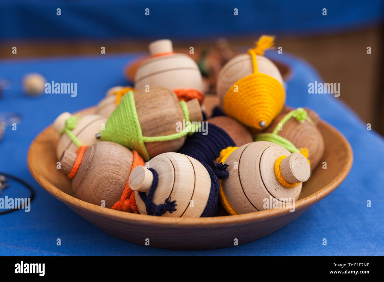 Traditional wooden spinning tops on sale at a craftworks stall in Tenerife, Canary Islands, Spain. Stock Photo