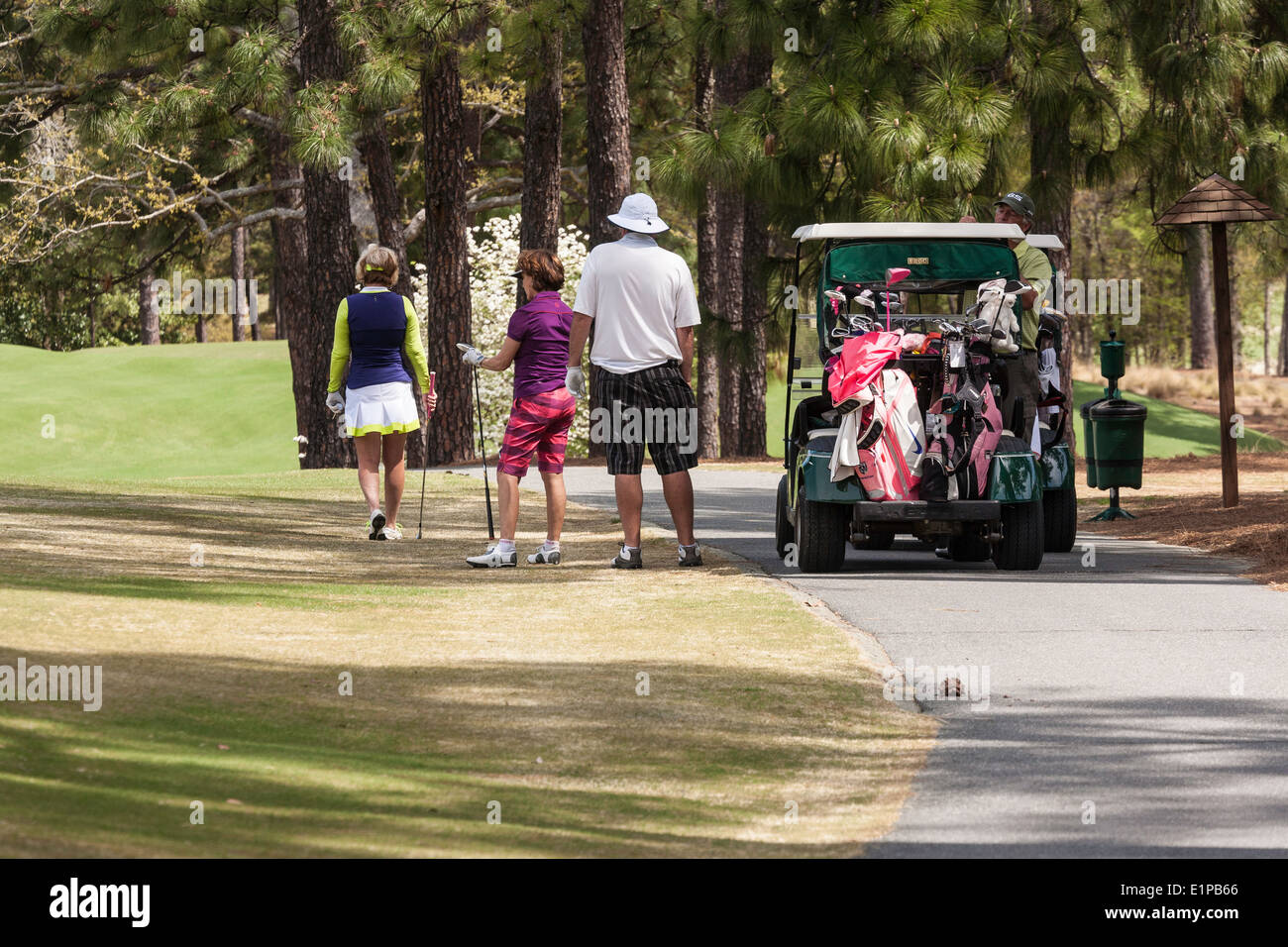 Man and Women Golfers and Cart, PInehurst Resort Golf Course, Pinehurst, North Carolina, USA Stock Photo