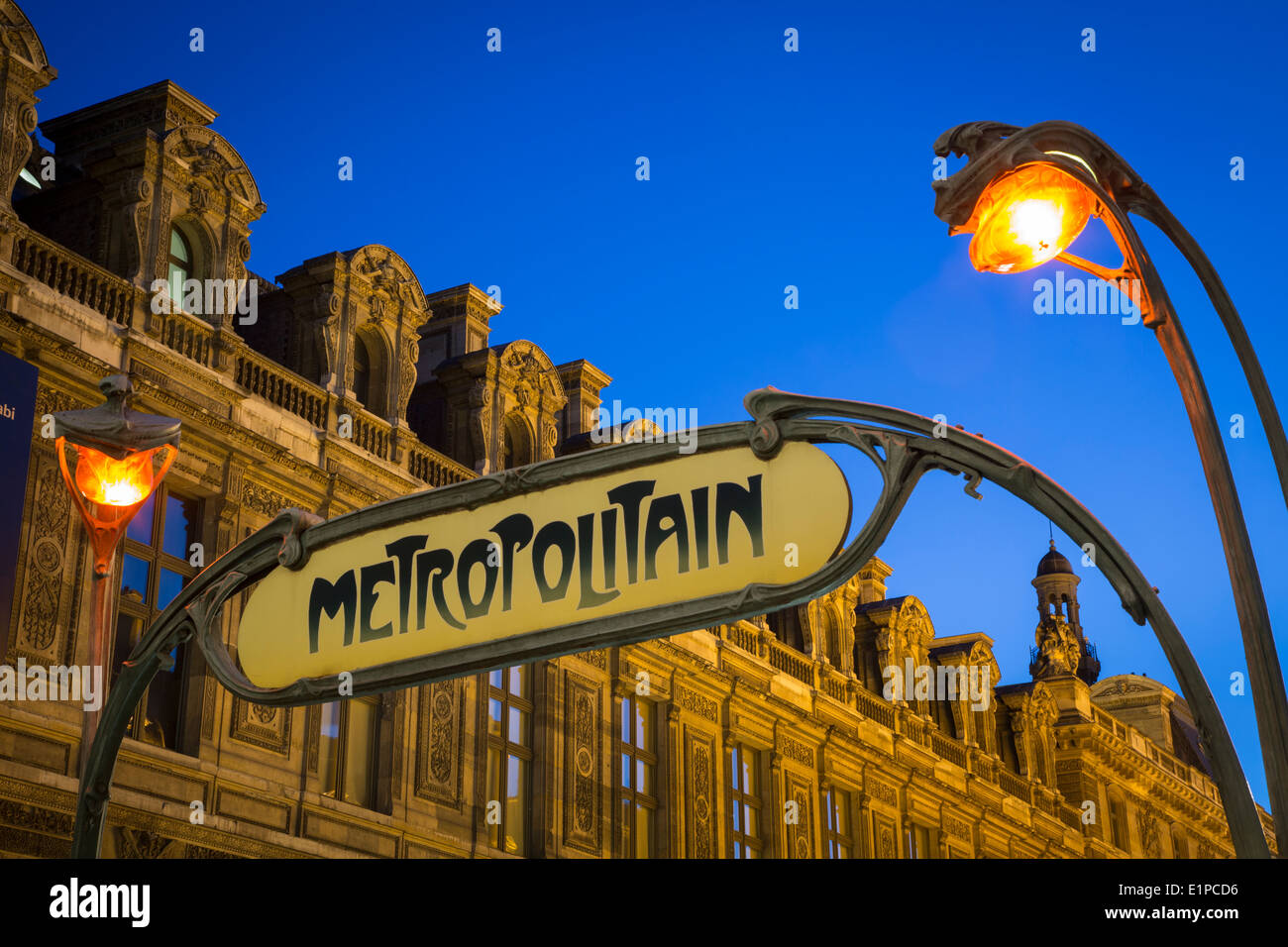 Metro sign and lights at Palais Royal/Musee du Louvre Metro stop with Musee du Louvre beyond, Paris France Stock Photo