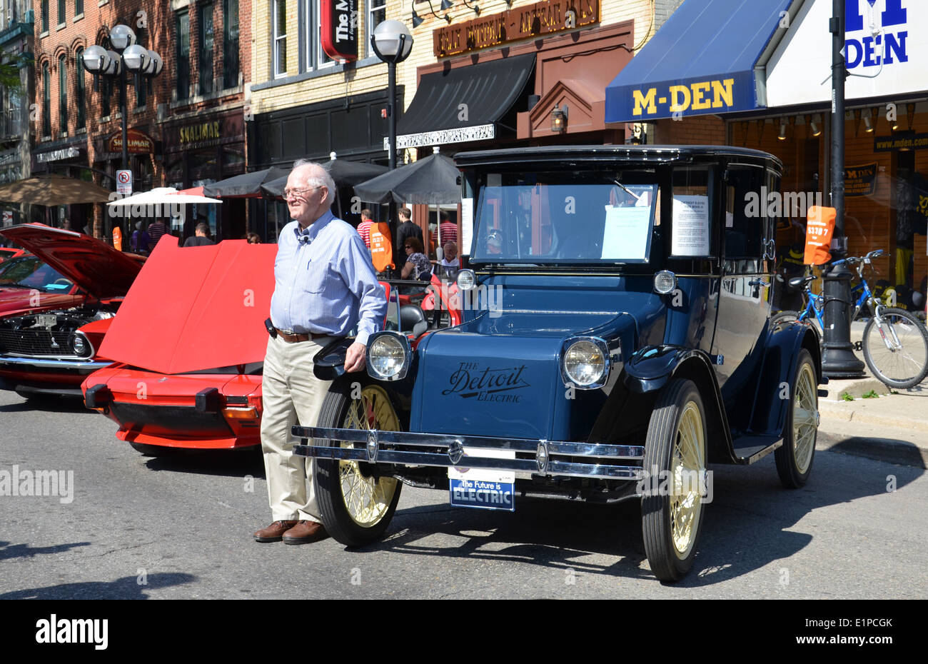 Owner Jack Beatty poses in front of his 1925 Detroit Electric at the Rolling Sculpture car show July 12, 2013 in Ann Arbor, MI Stock Photo