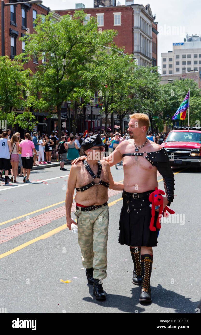 Two gay men walking down Market Street in downtown Philadelphia, PA at 2014 PrideDay on Sunday June 8th - Philadelphia's annual LGBT Pride Parade and Festival Stock Photo