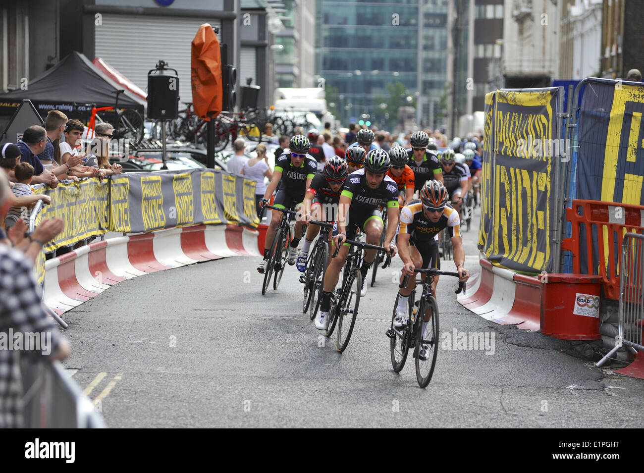 London, UK. 07th June, 2014. The peloton racing around Smithfield Market during the Leigh Day Kermesse Bike Race during the Jupiter London Nocturne cycling event. The race was won by Alex Minting (Neon-Velo) with a time of 37min06sec. Credit:  Michael Preston/Alamy Live News Stock Photo