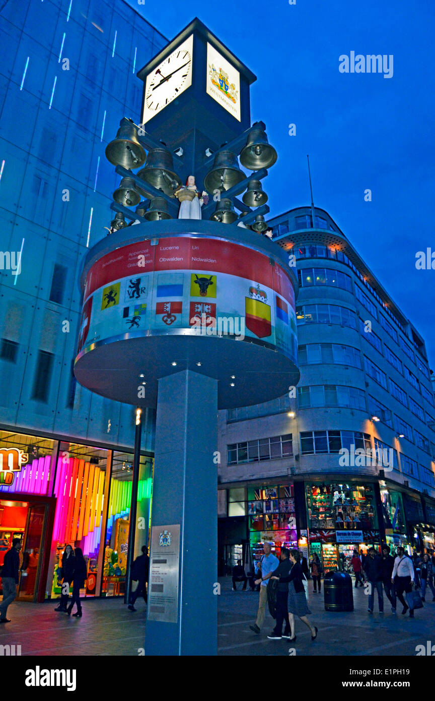 Leicester Square at night showing the Swiss Glockenspiel , West End
