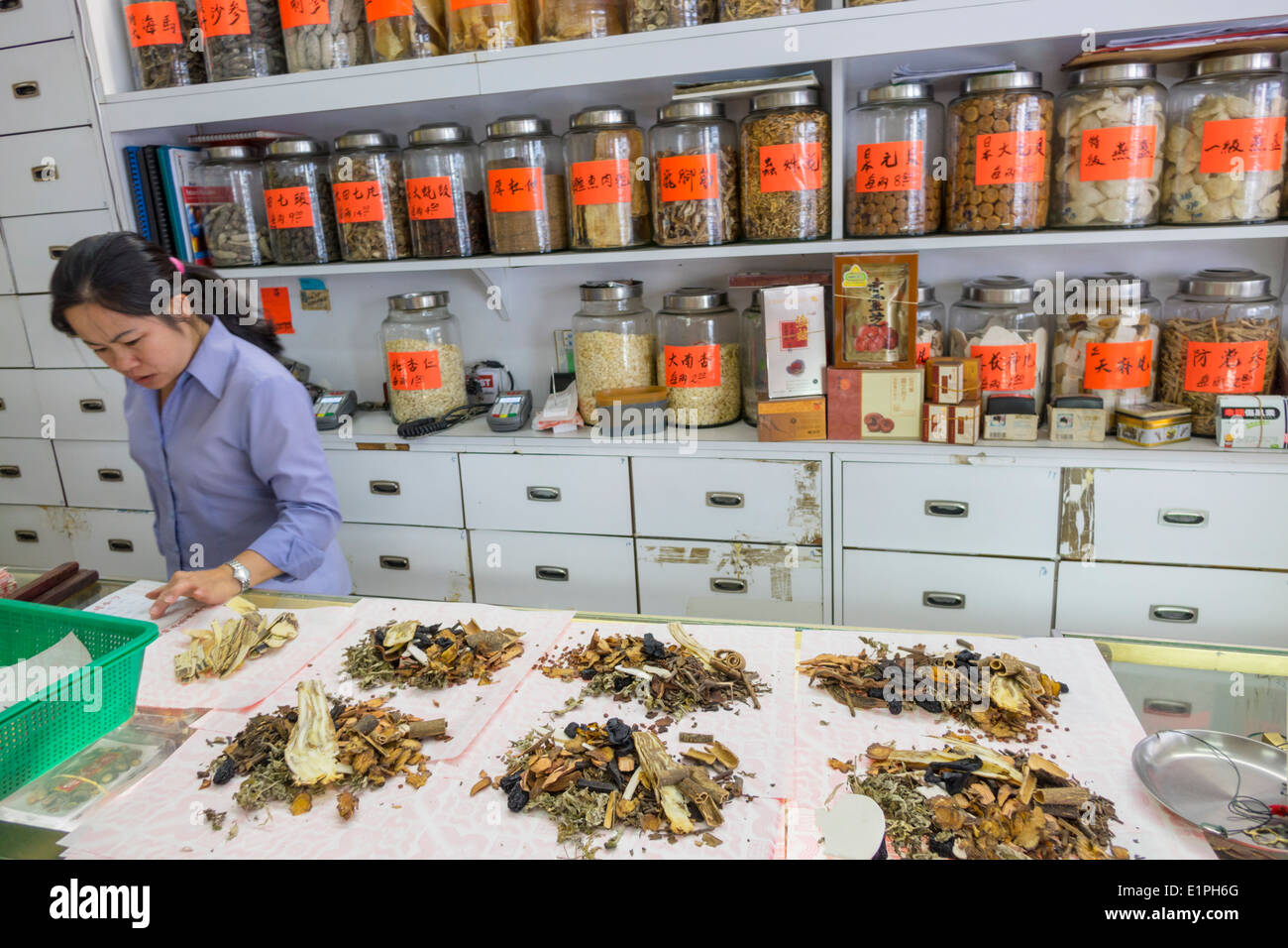 Brisbane Australia,Fortitude Valley,Chinatown,Brunswick Street,traditional,Chinese herbal medicine shop,Asian woman female women,herbalist,mixing,herb Stock Photo