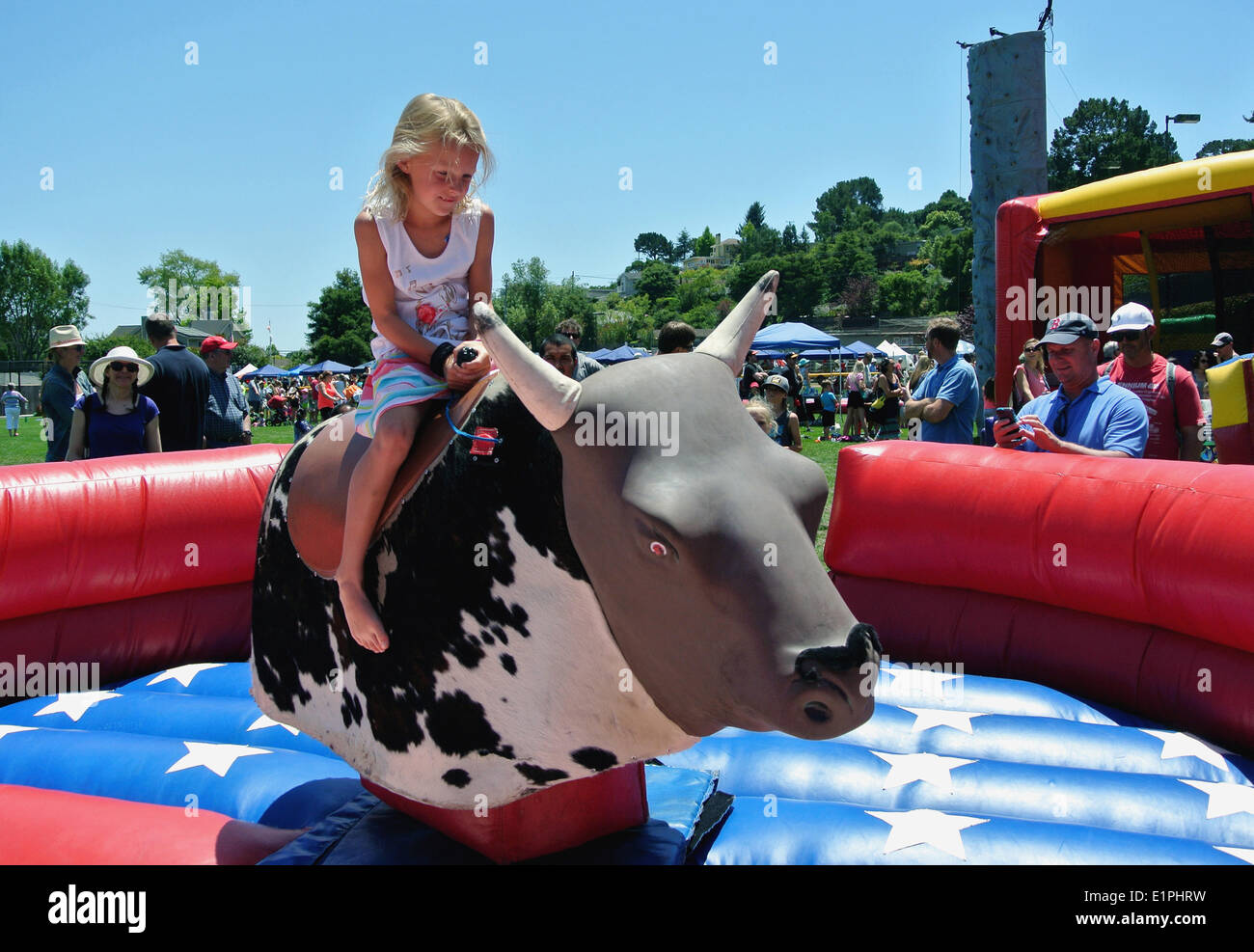Mill valley, Ca. May 8th,2014. girl rides mechanical bull at strawberry community 65th annual festival in Mill valley, california Stock Photo