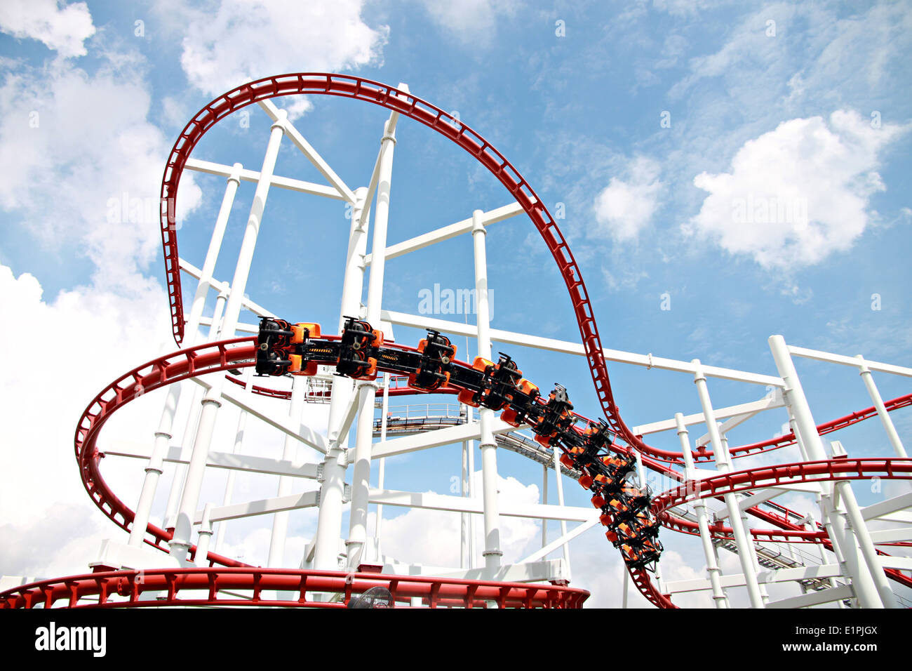 Rollercoaster against blue sky in amusement park. Stock Photo