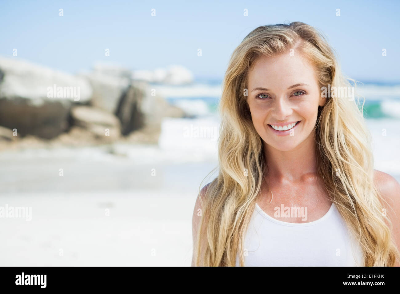 Gorgeous blonde smiling at camera on the beach Stock Photo - Alamy