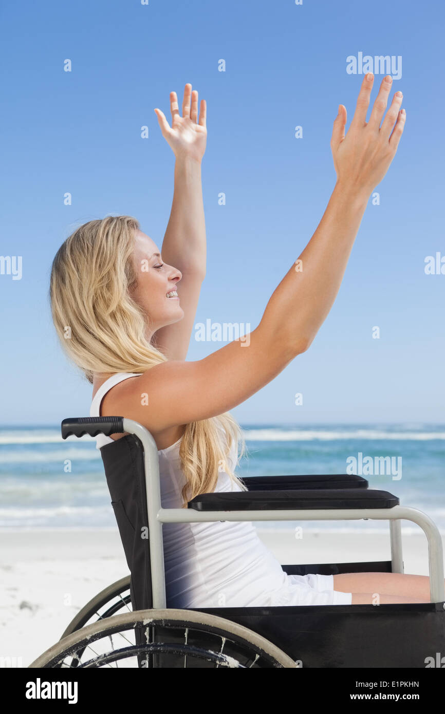 Wheelchair bound blonde smiling on the beach Stock Photo Alamy