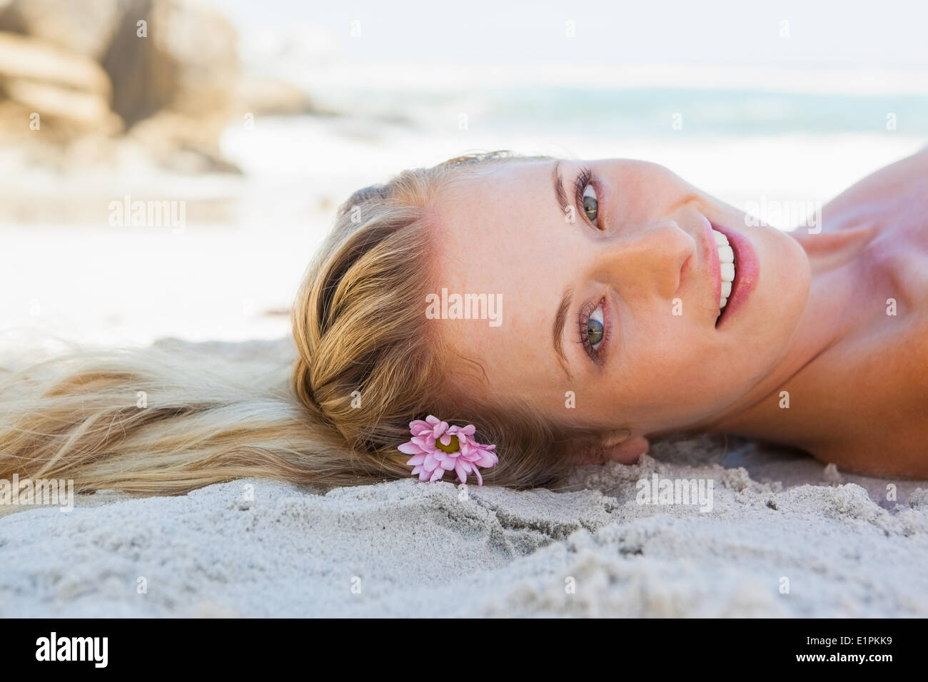 Pretty carefree blonde lying on the beach Stock Photo