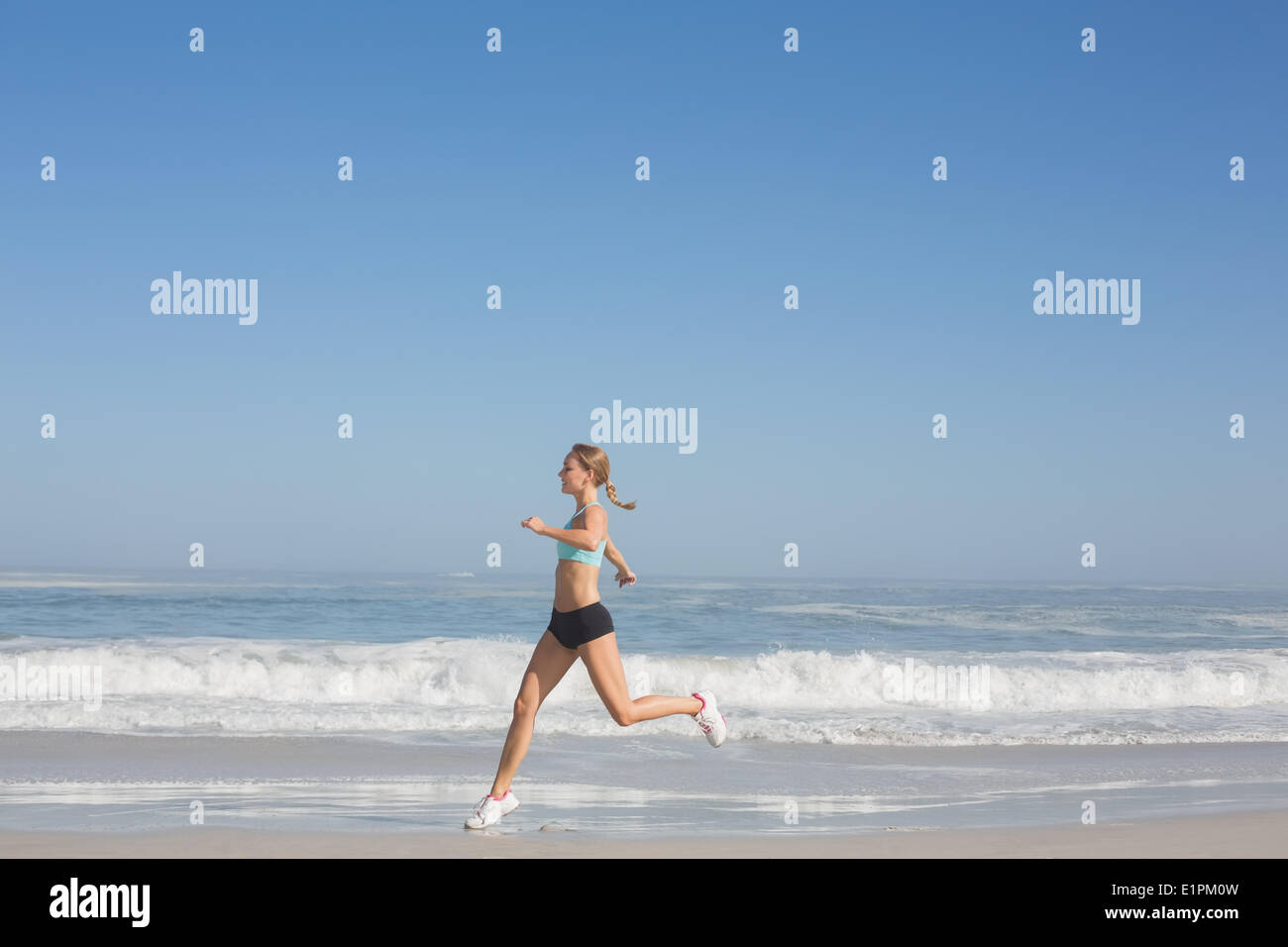 Fit woman jogging on the beach Stock Photo - Alamy