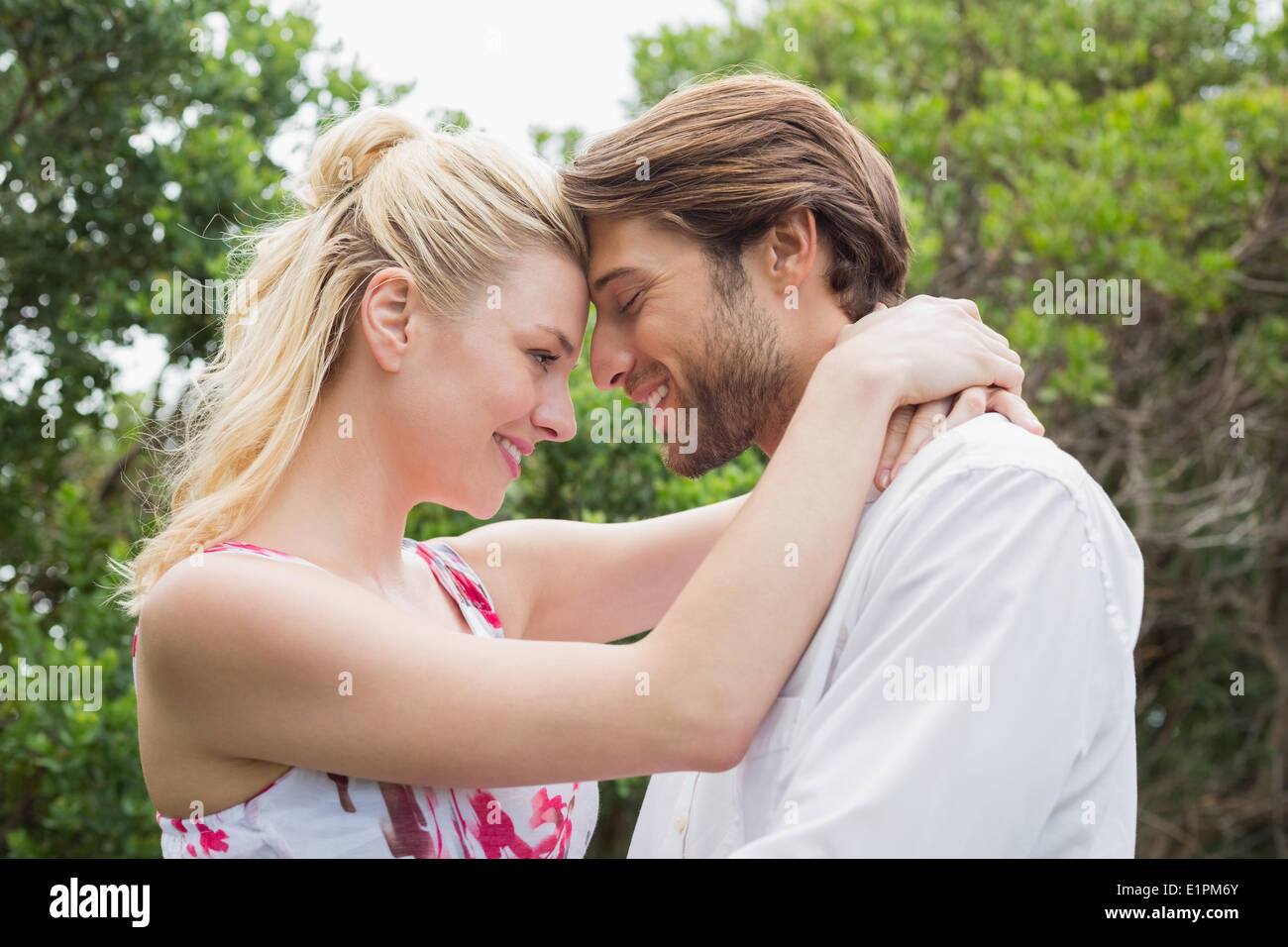 Cute couple standing outside hugging Stock Photo