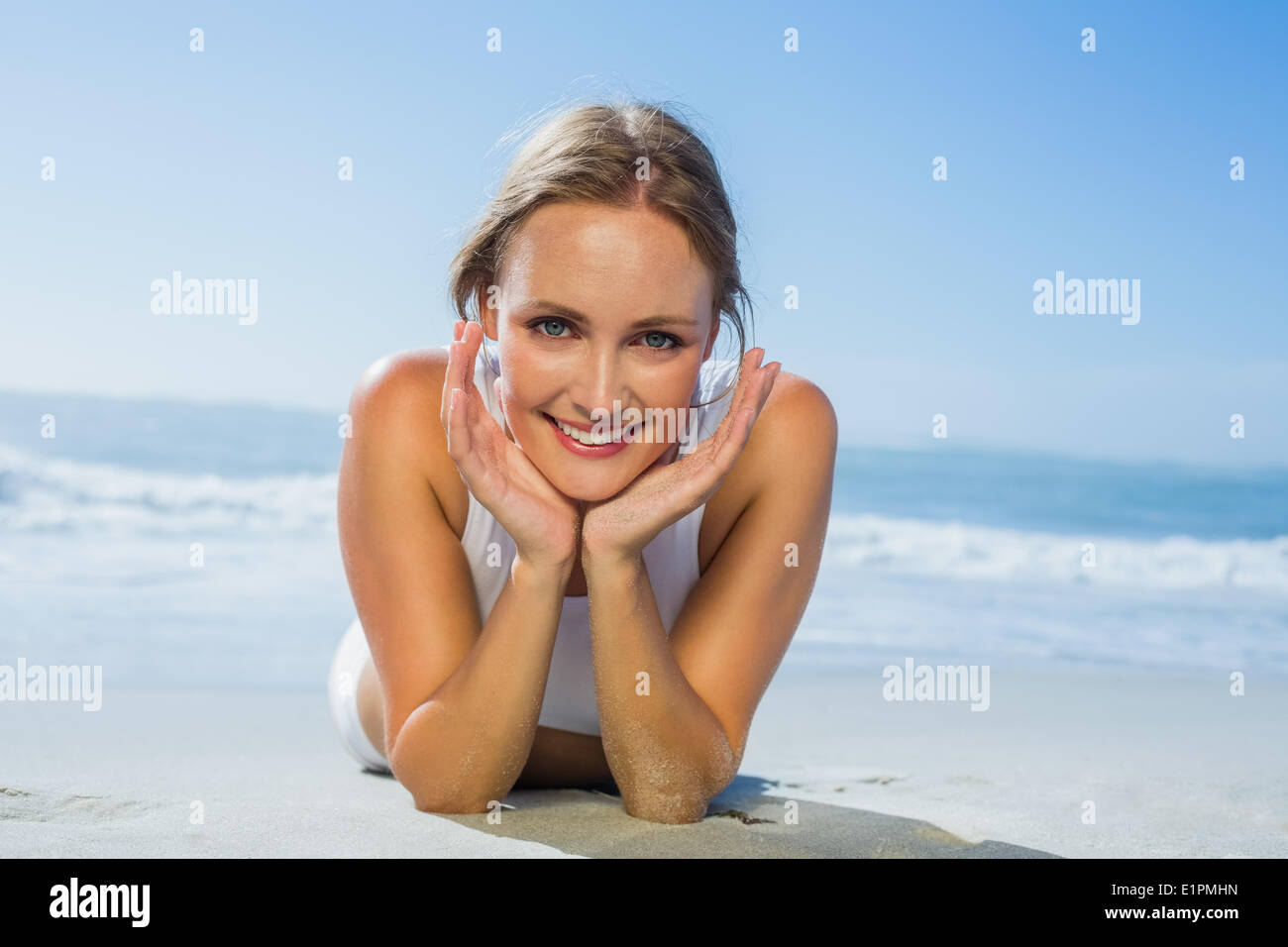 Beautiful woman lying on beach hi-res stock photography and images - Alamy