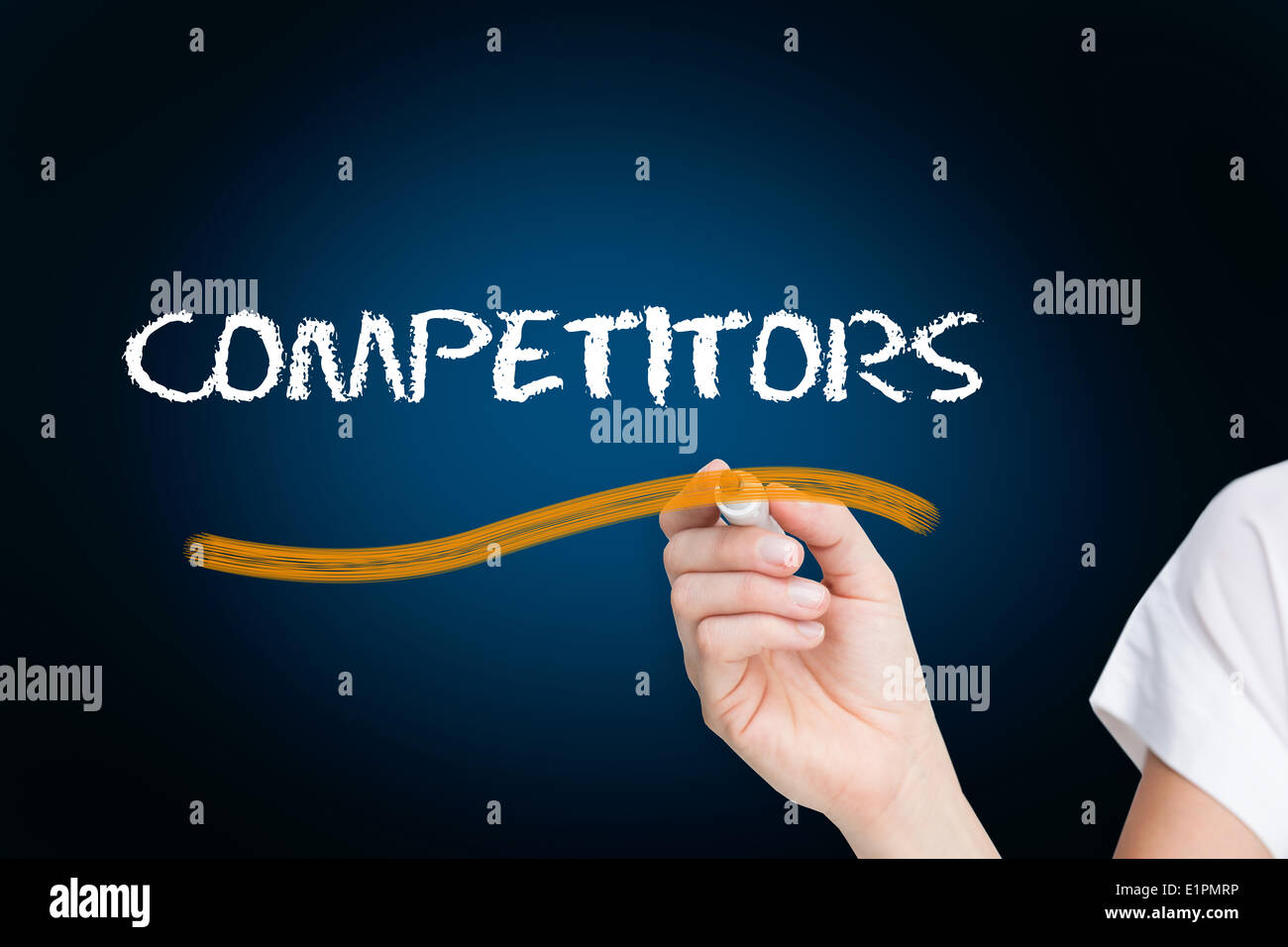 Businesswoman writing the word competitors Stock Photo
