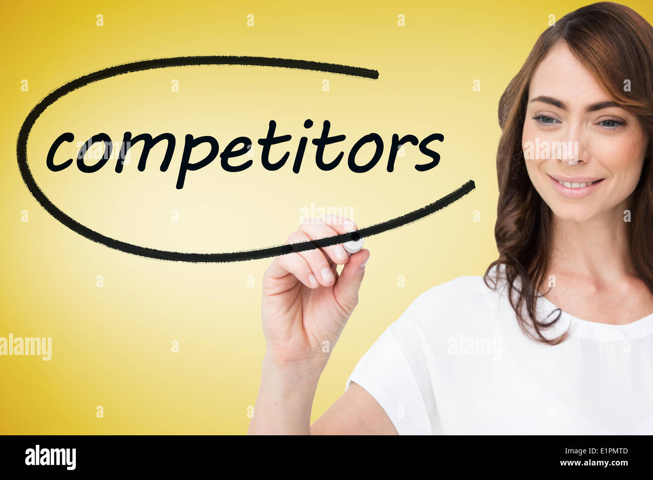 Businesswoman writing the word competitors Stock Photo