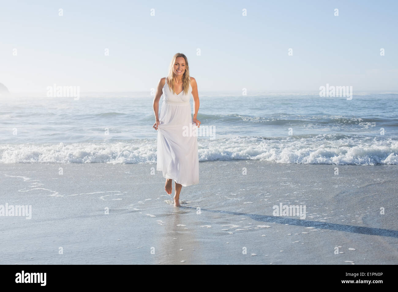 Pretty blonde at the beach in white sundress Stock Photo