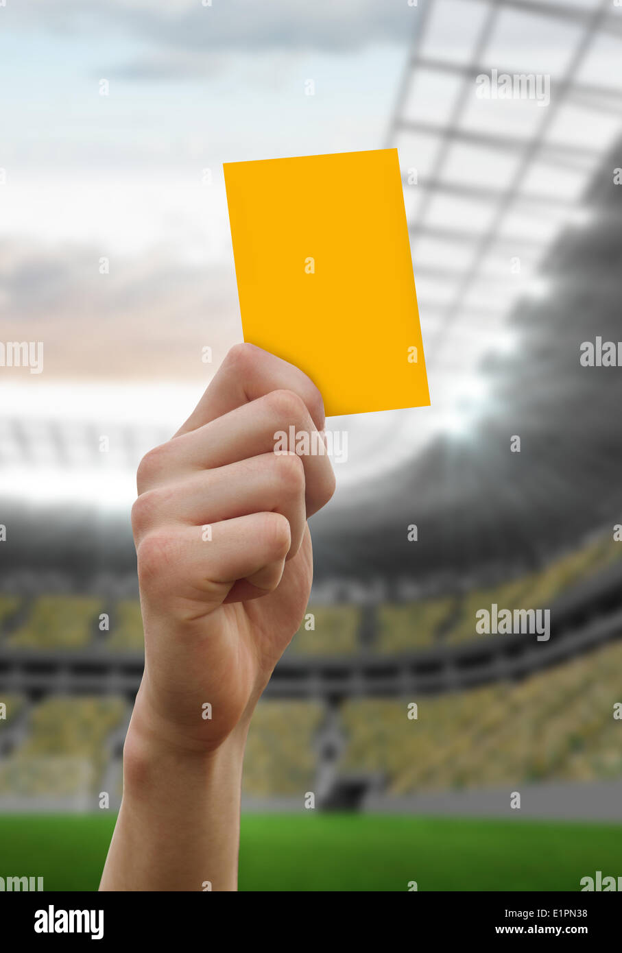 Composite image of hand holding up yellow card Stock Photo