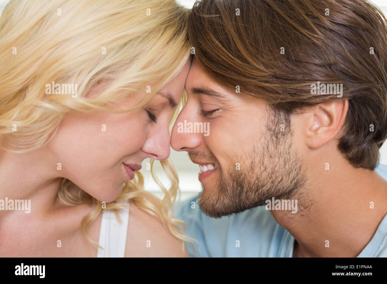 Cute couple facing each other with eyes closed Stock Photo