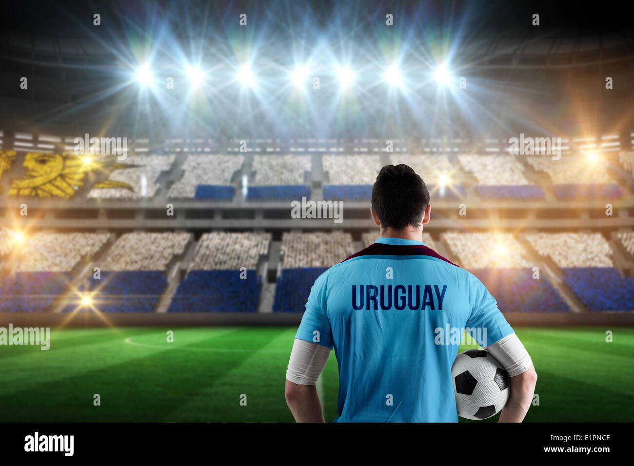 Composite image of uruguay football player holding ball Stock Photo
