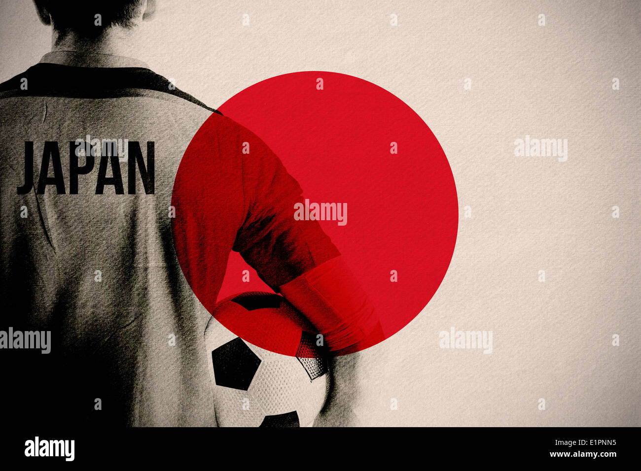 Composite image of japan football player holding ball Stock Photo