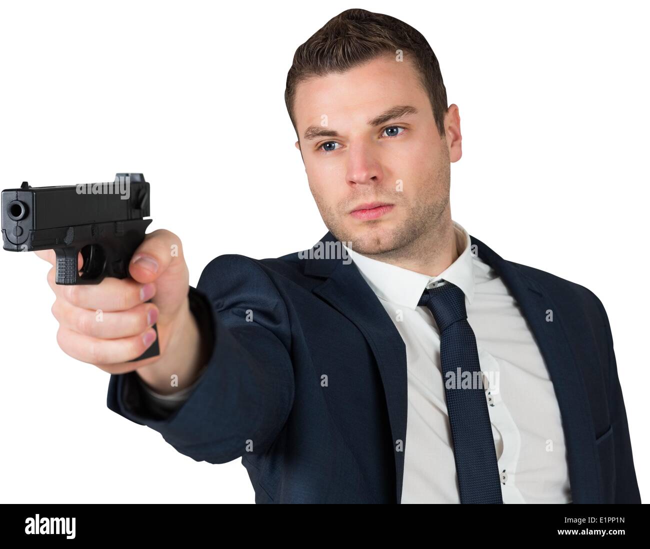 Serious businessman pointing a gun Stock Photo