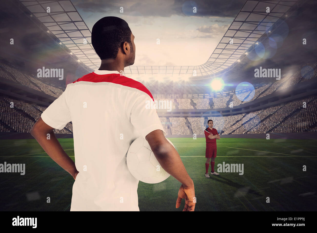 Football players facing off in large stadium Stock Photo